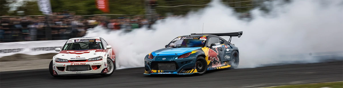 Tandem battle in Drift Masters — Red Bull GT86 chasing a Worthouse S15 in a cloud of tire smoke